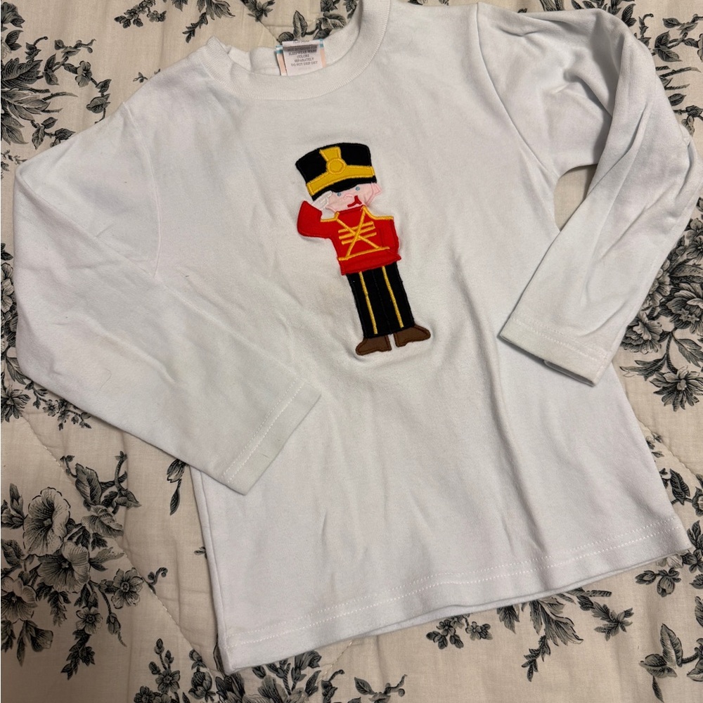 🎅 Charming White Long Sleeve Kids Shirt with Toy Soldier Design